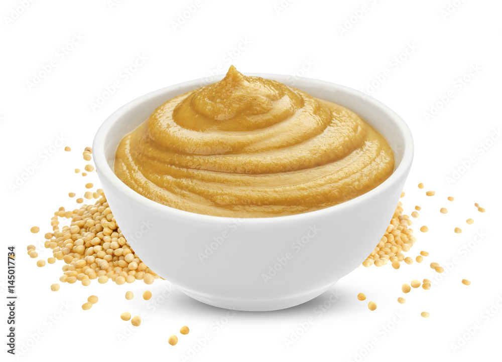 Mustard sauce in bowl and mustard seeds isolated on white background