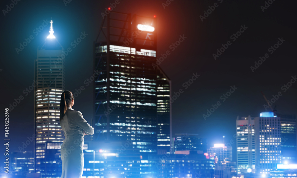 Woman looking at night city