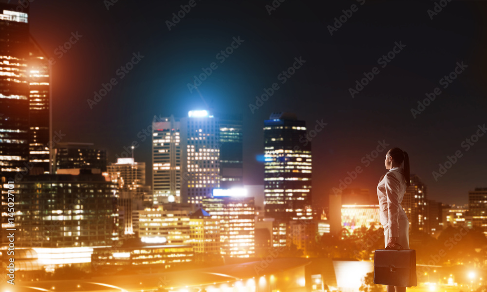 Woman looking at night city