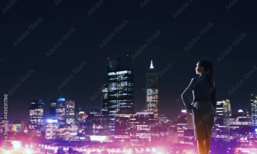 Woman looking at night city