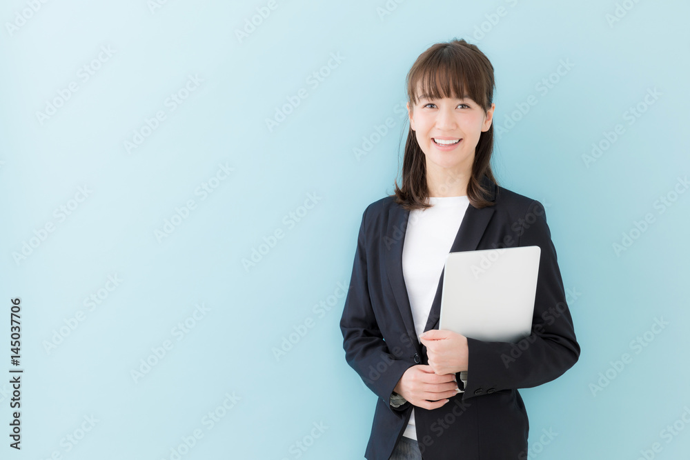 portrait of asian businesswoman isolated on blue background