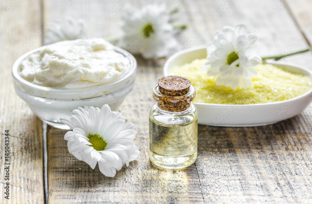 close up body care camomile cosmetic products on wooden desk background