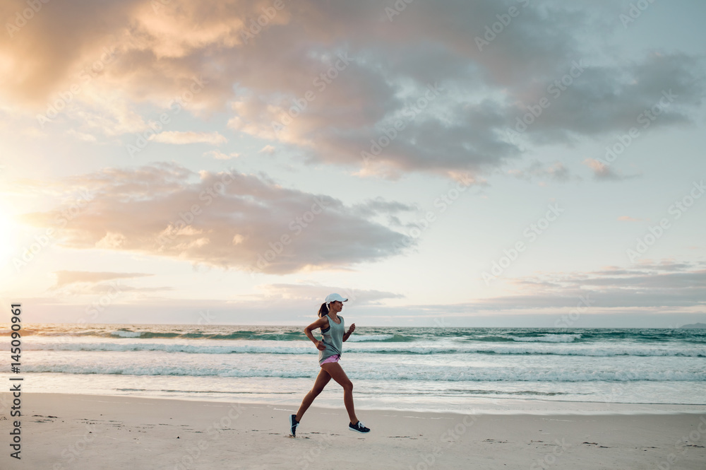 Fitness woman doing running exercise on the beach