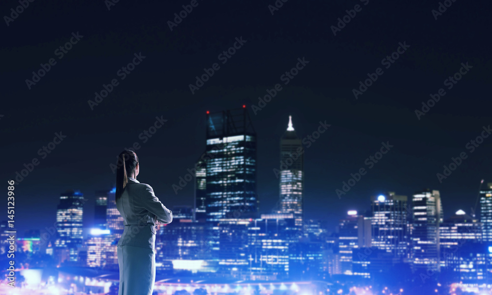 Woman looking at night city