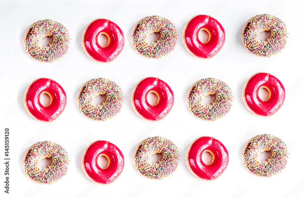 sweet colorful donuts with topping on white desk background top view pattern