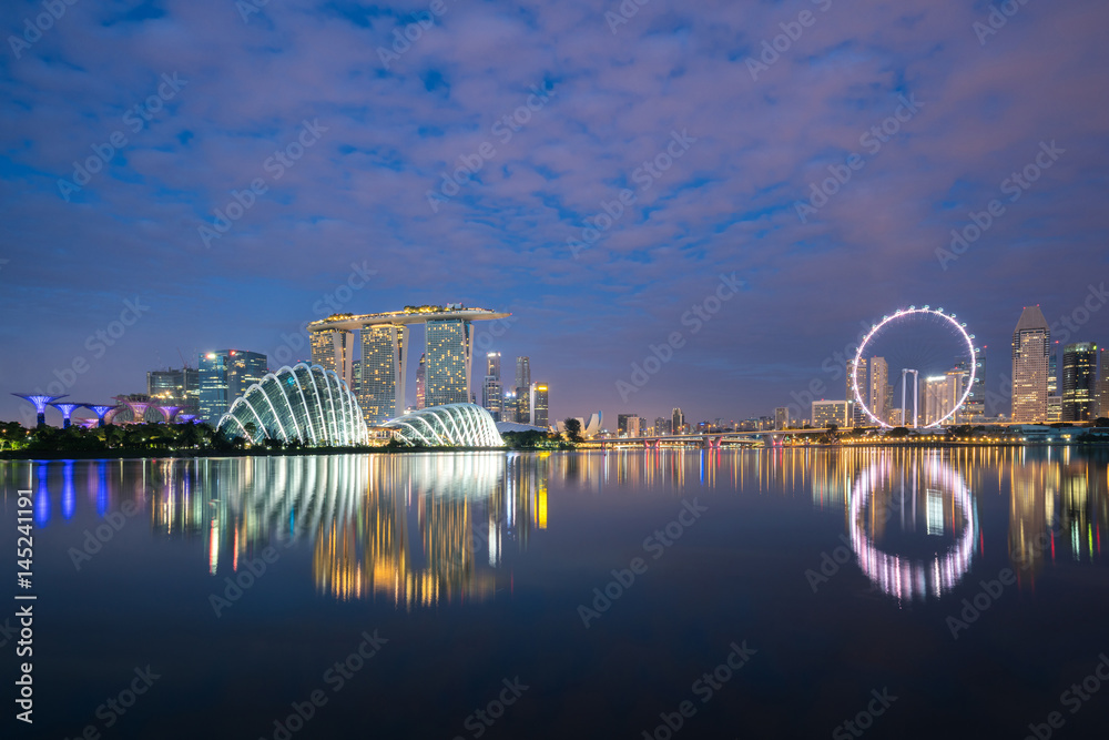 Singapore business district skyline at night in Marina Bay, Singapore.