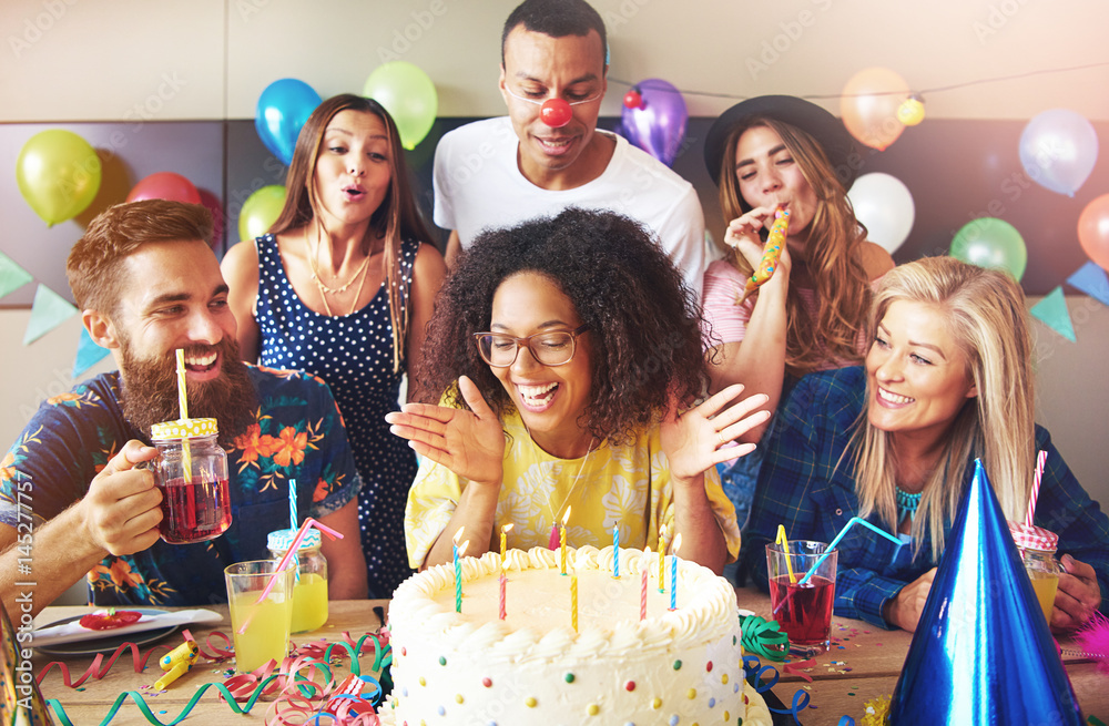 Vivacious woman blowing out her birthday candles