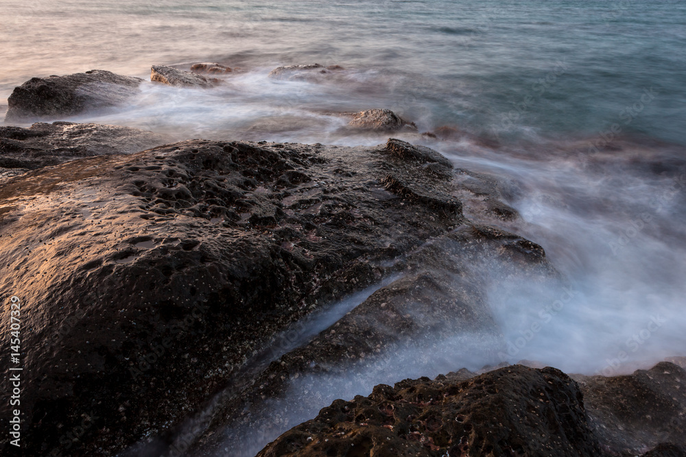 Waves and rocks shore long exposure