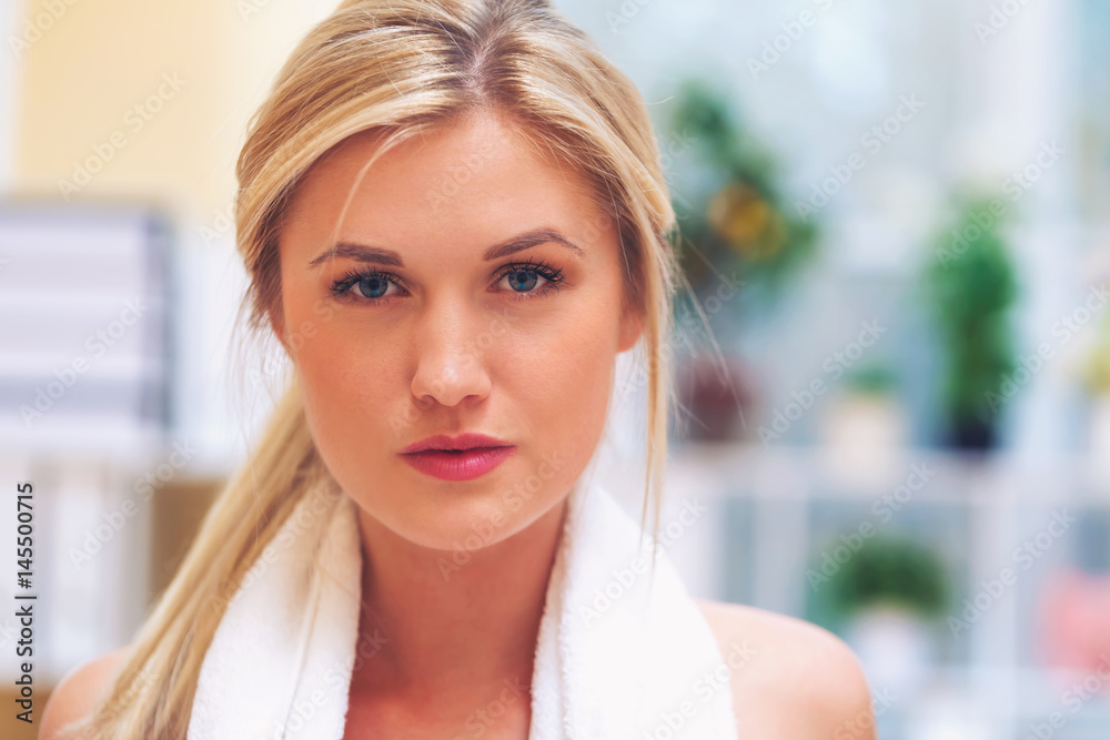 Young fit healthy woman with towel