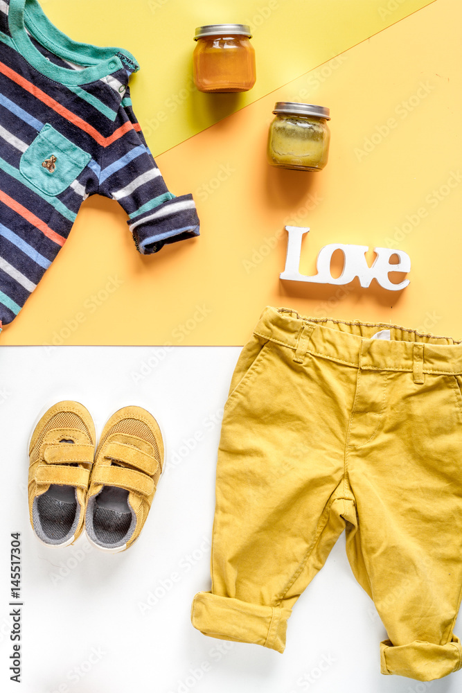 kids desk design with toys and clothes yellow white background top view