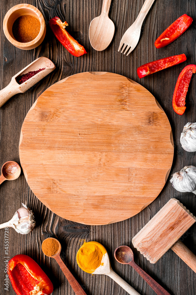 Professional kitchen with spices for cook on wooden background top view