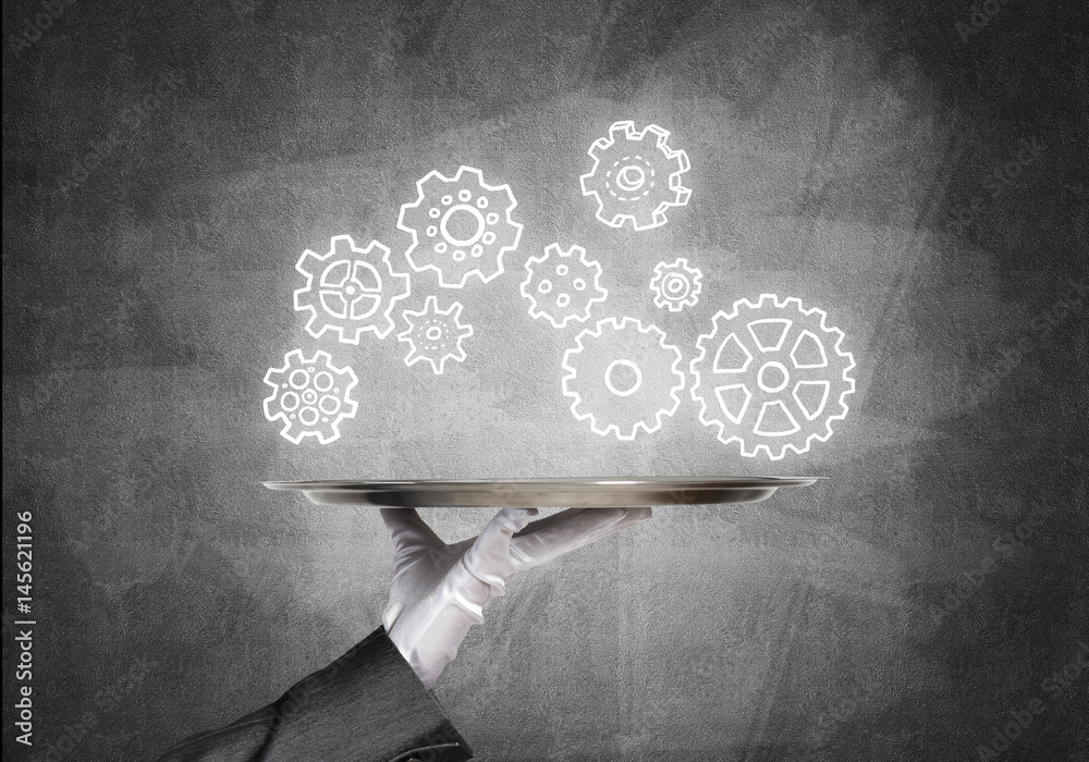 Waiter hand with empty silver tray and drawn gears concept