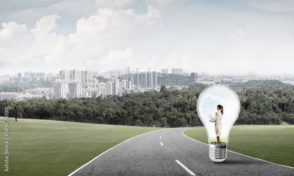 Businesswoman inside light bulb