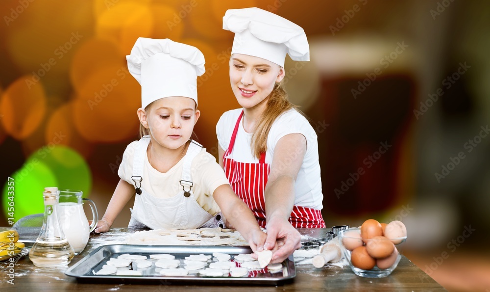 Woman and child cooking.