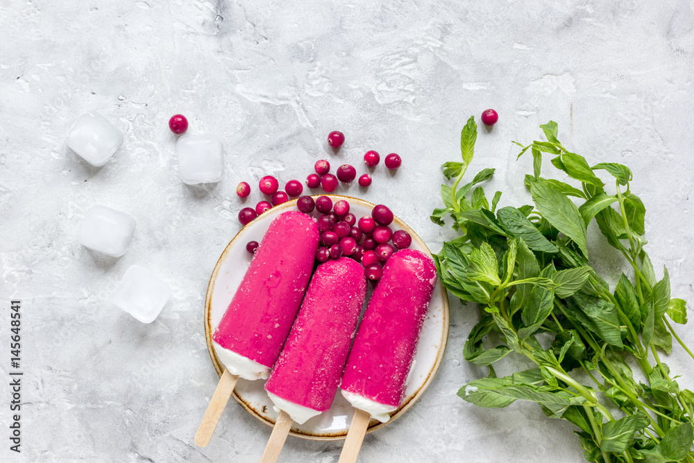 summer dessert with popsicle and red berries stone desk background top view