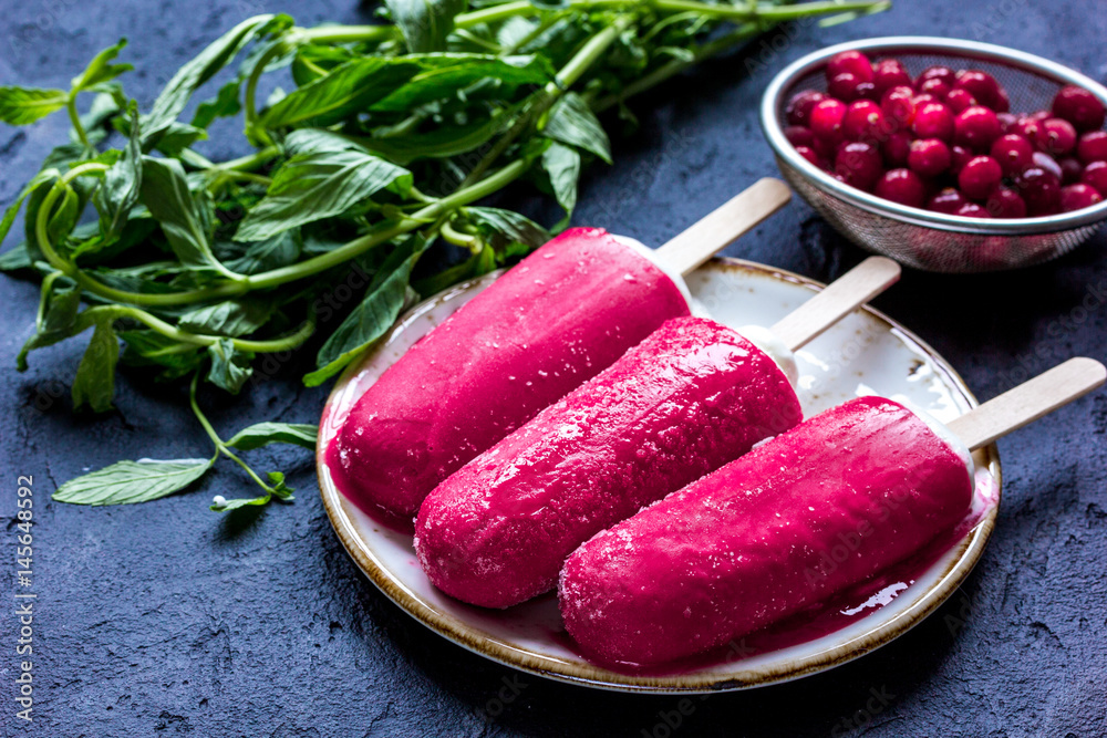 summer dessert with popsicle and red berries stone desk background