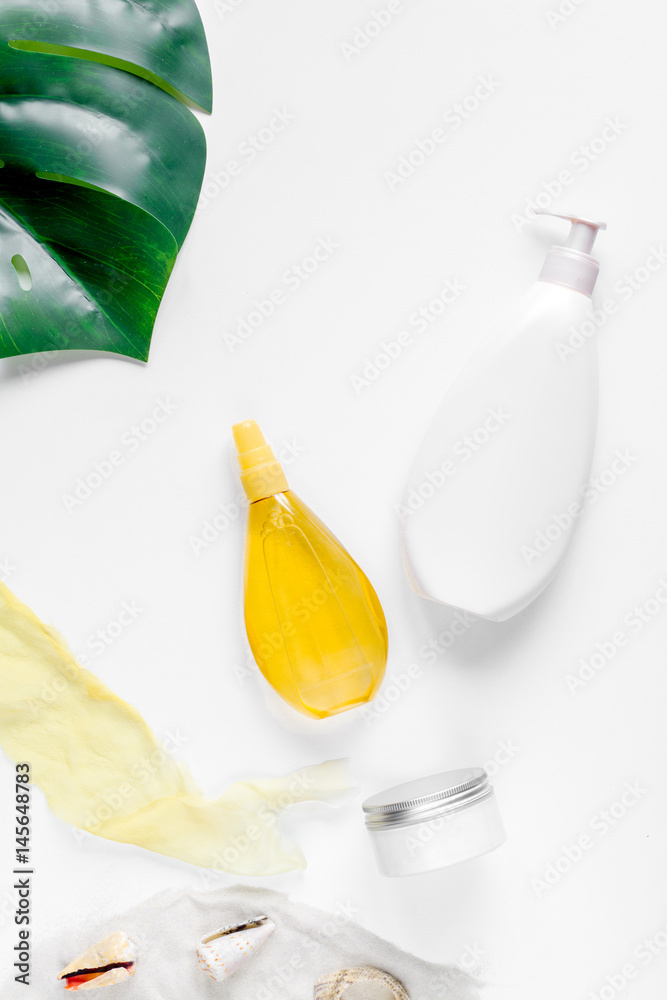 Sun protection concept with cream and lotion on white background top view