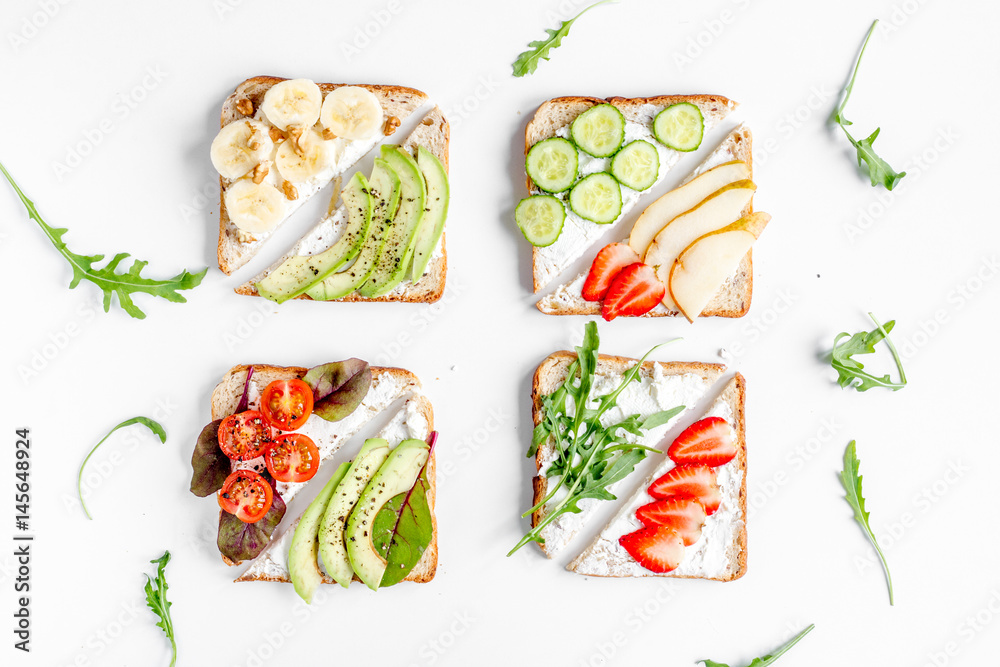 healthy breakfast with sandwiches set on white background top view