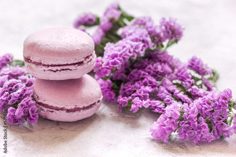 Trendy woman pattern with spring flowers and macaroons on plate