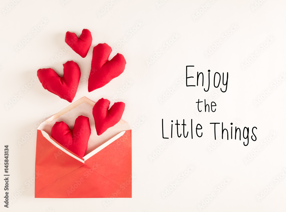 Enjoy The Little Things message with red heart cushions