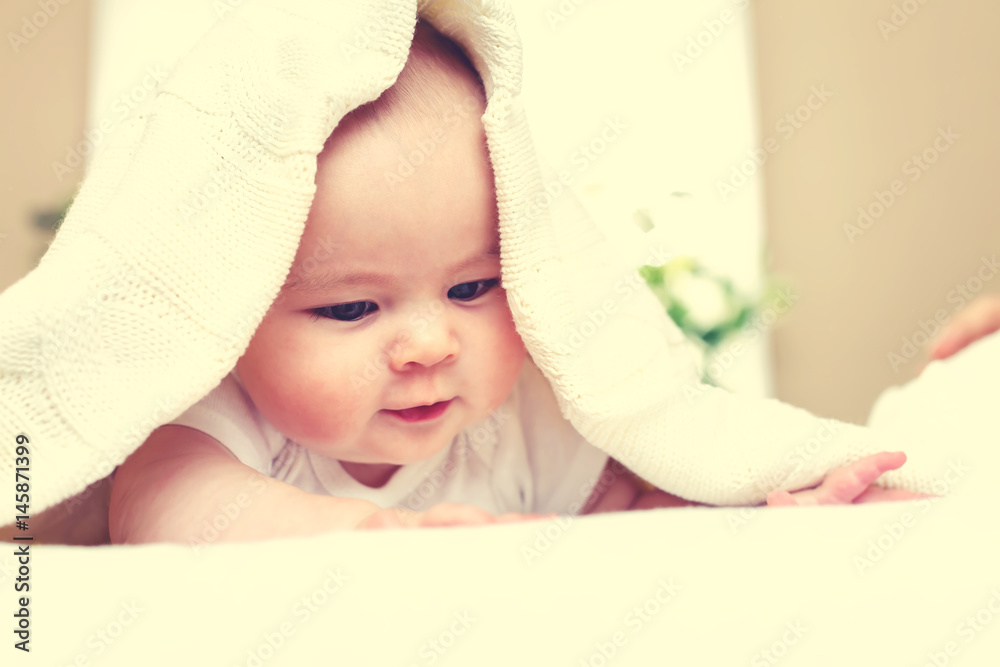 Happy newborn baby girl smiling