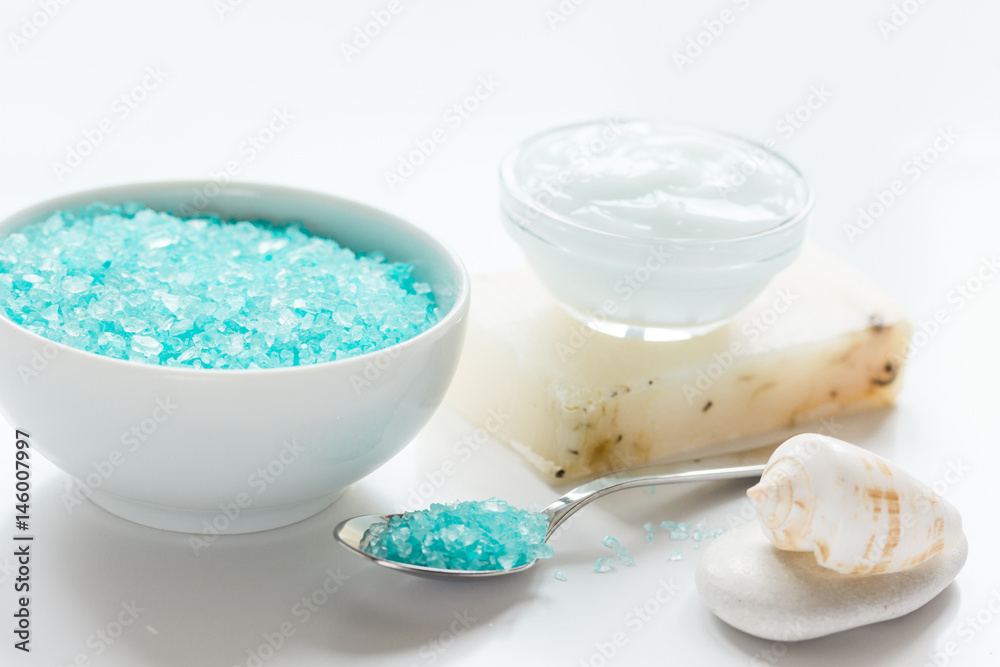 Home cosmetic with cream and blue sea salt on white background