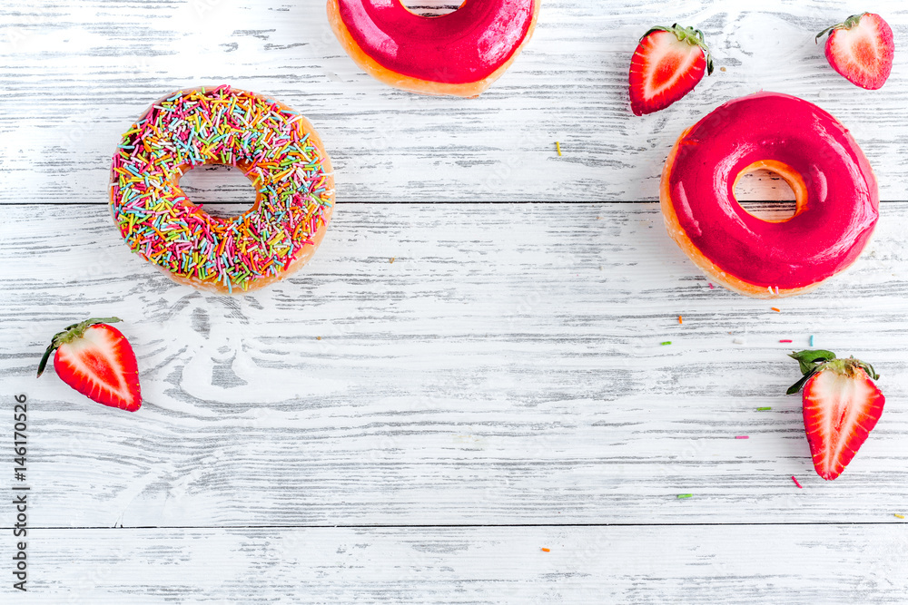 lunch with donuts and strawberry on wooden table background top view mock up