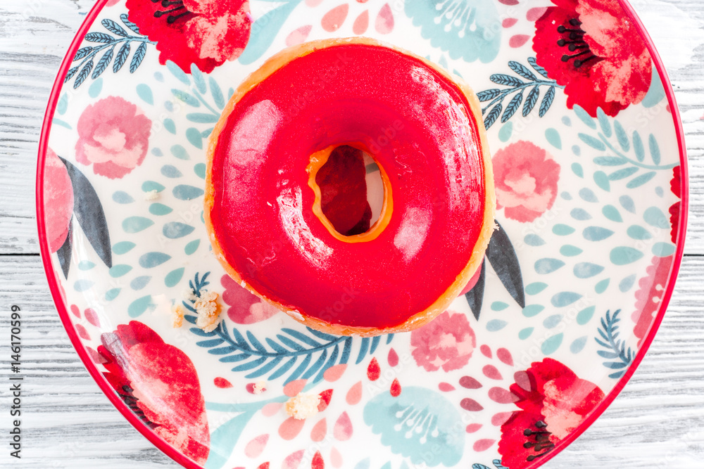 sweet colorful donuts with topping on plate background top view