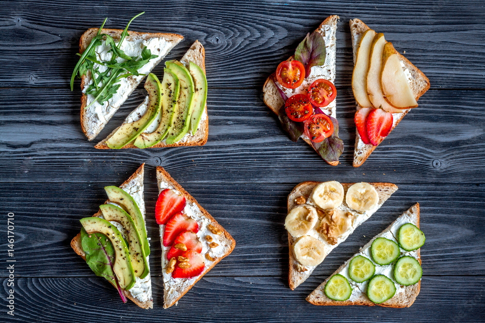 sandwiches set on dark table background top view