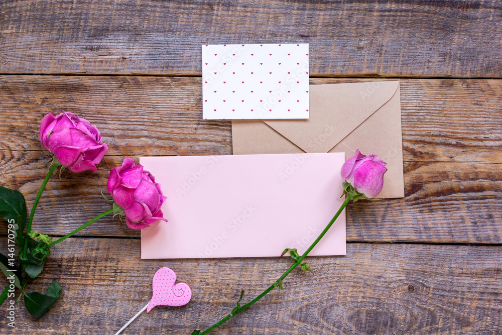 pink peony and greeting-card for present on wooden background top view mockup