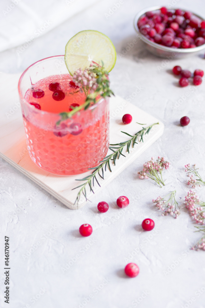 summer homemade juice with lime and berries on stone table background