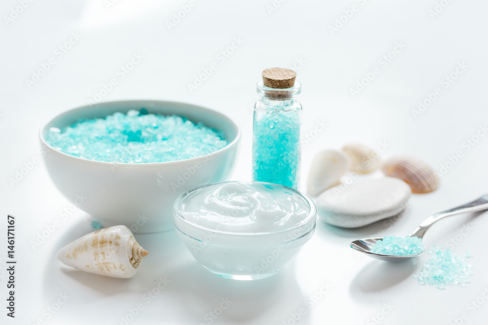 sea salt and body cream on white desk background