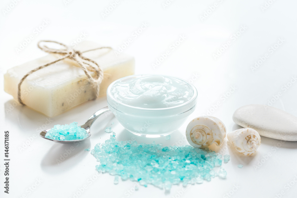 spa composition with blue sea salt and natural soap on white desk background