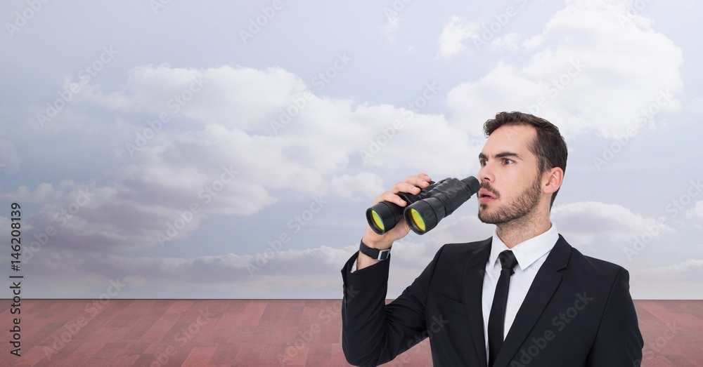 Shocked businessman looking away while holding binoculars