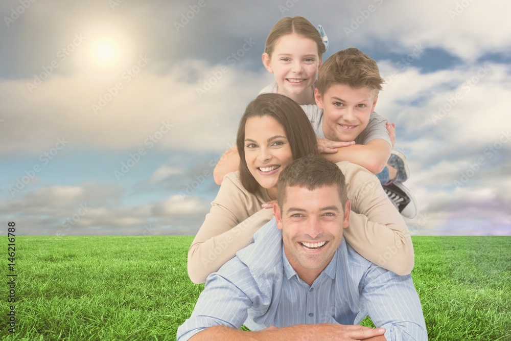 Happy family lying on each other at park