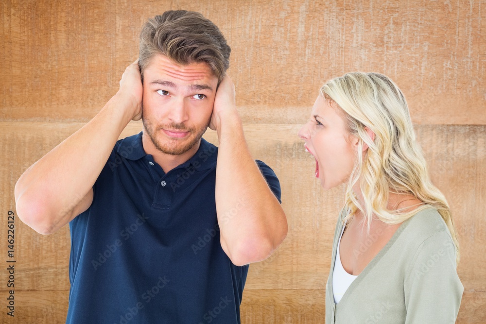 Woman shouting on man while fighting at home