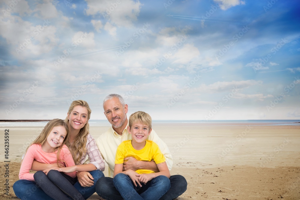 Portrait of happy family at beach against sky