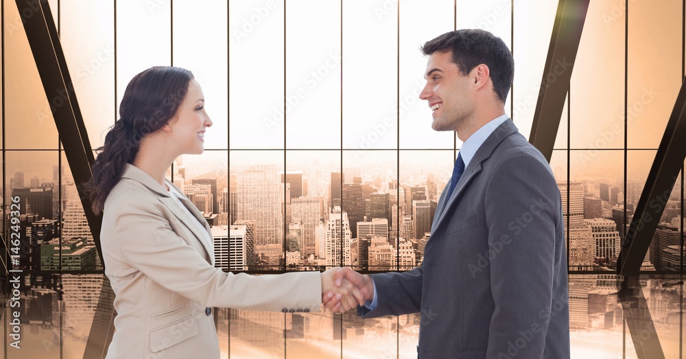 Side view of male and female professionals shaking hands