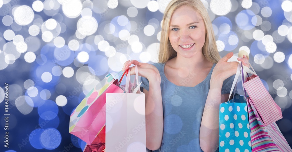 Composite image of happy young woman with shopping bags