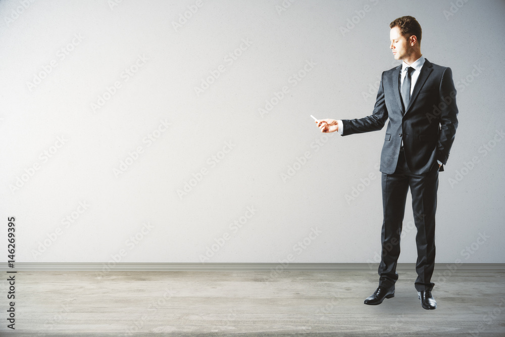 Businessman drawing on light wall