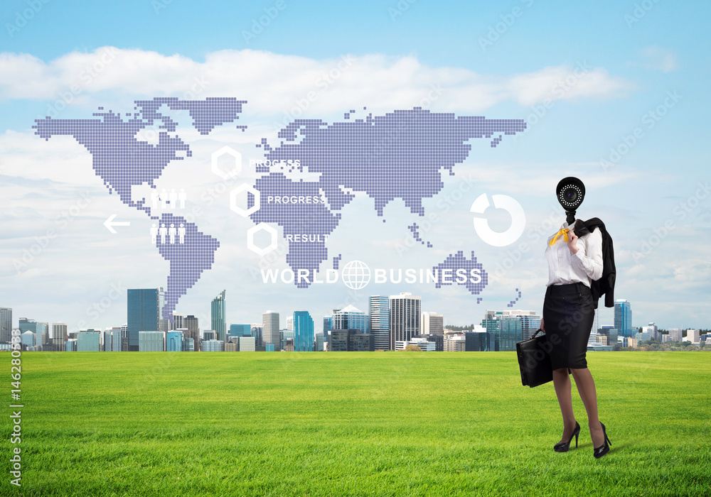 Camera headed woman standing on green grass against modern cityscape