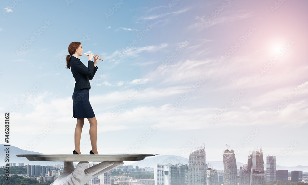 Attractive businesswoman on metal tray playing fife against cityscape background