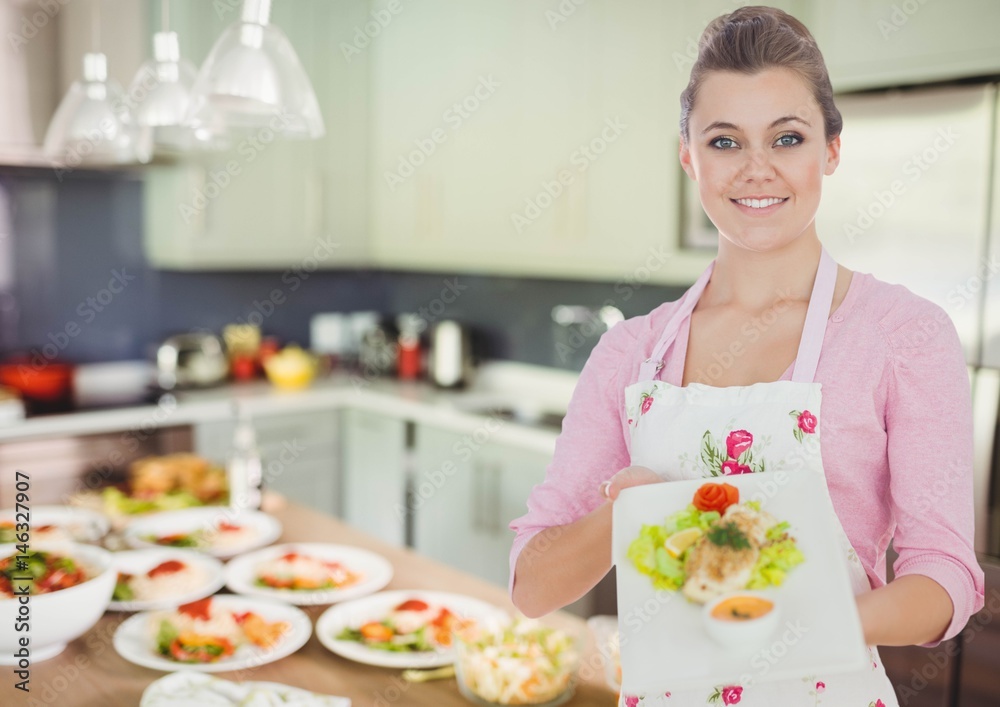 woman showing the plate in the kitchen