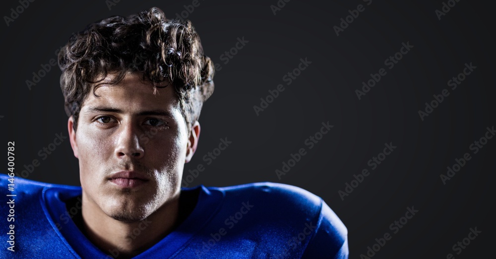 Football player against dark grey background