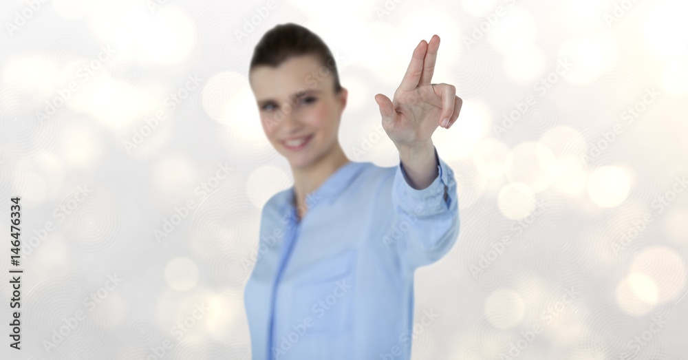 Smiling businesswoman gesturing over bokeh