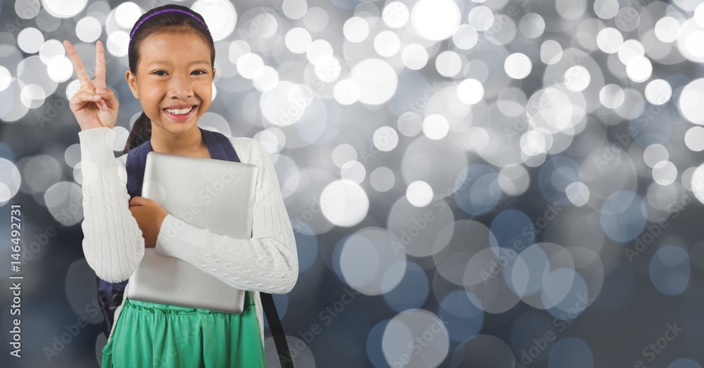 Smiling schoolgirl showing victory sign