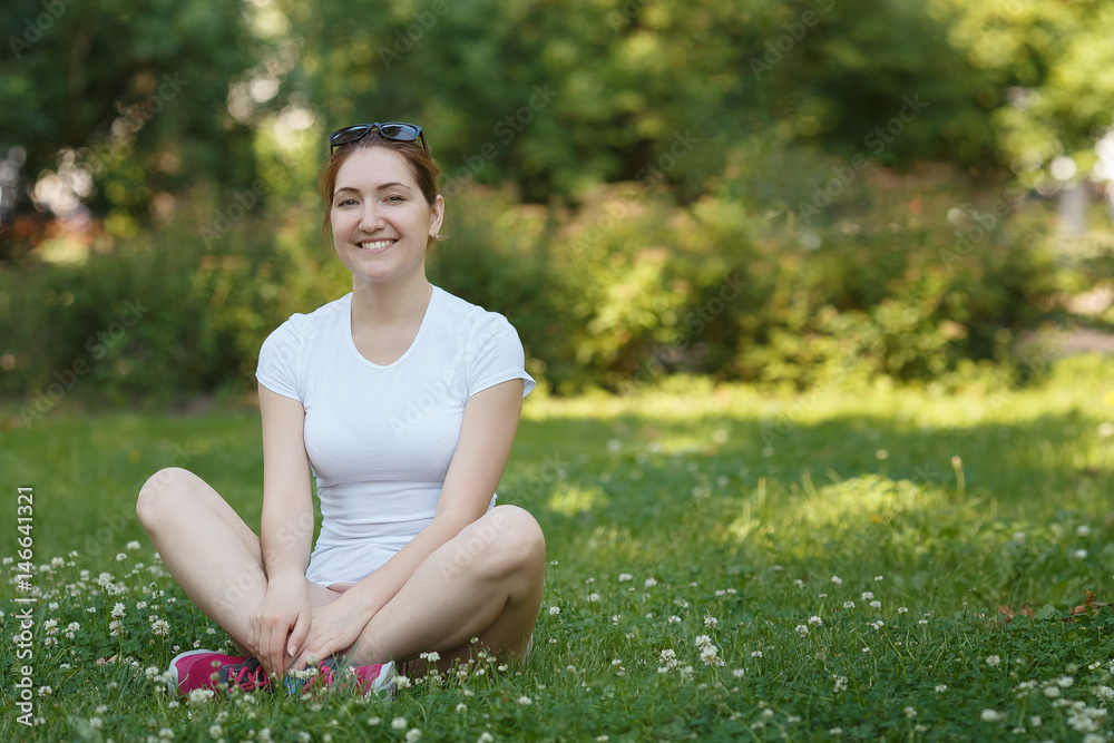 Young beautiful woman looking to camera - outdoor in nature.