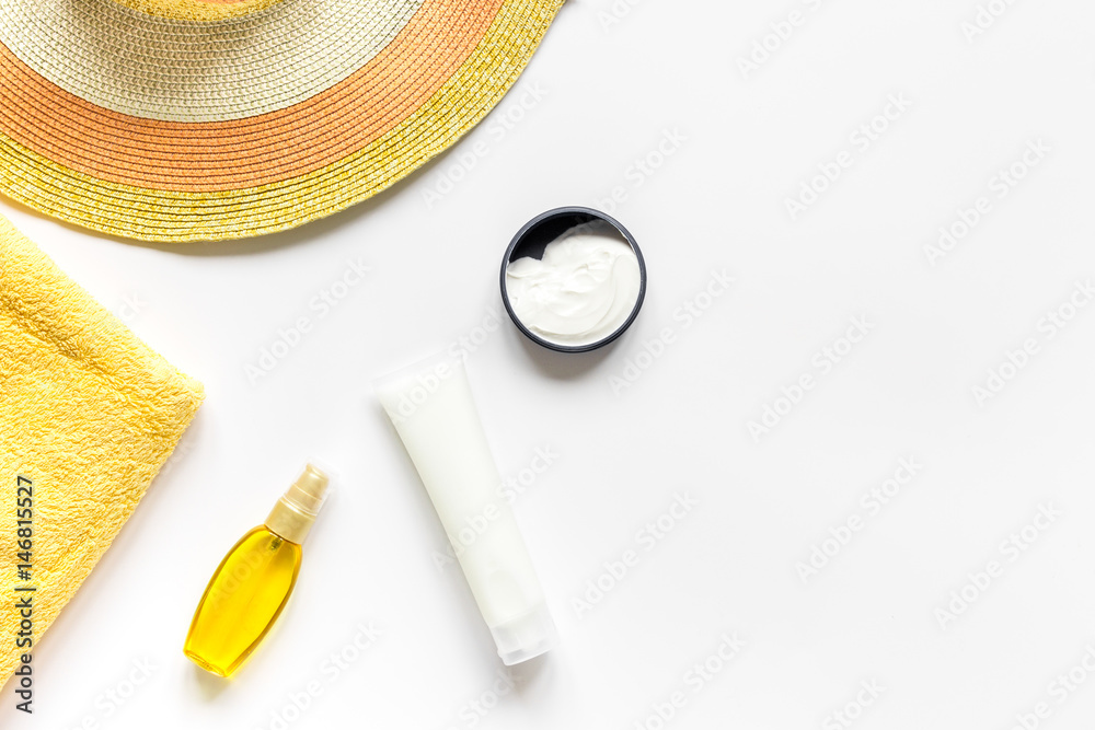 Sun protection composition with lotion and cream on white background top view mockup