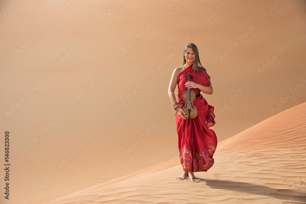 Woman in a red dress playing violin.