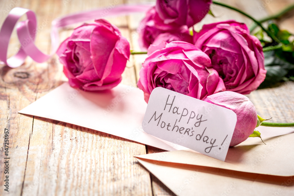 present design with Mothers day text and greeting-card on wooden desk